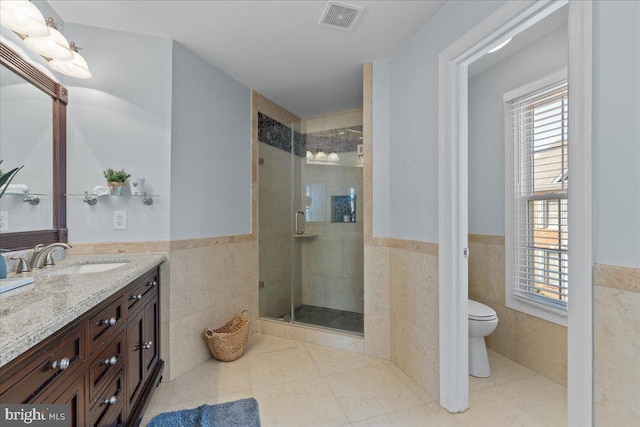 full bathroom featuring a shower stall, tile walls, visible vents, and tile patterned floors