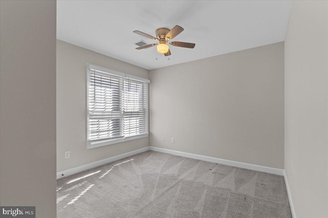 unfurnished room featuring carpet flooring, a ceiling fan, and baseboards