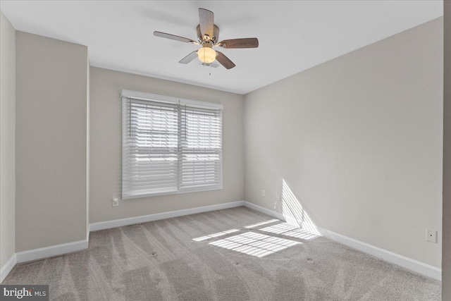 unfurnished room featuring carpet, baseboards, and ceiling fan