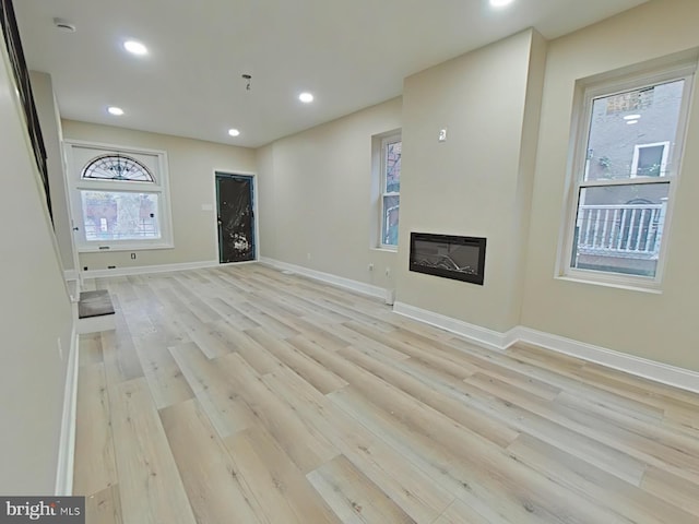 unfurnished living room featuring light hardwood / wood-style flooring