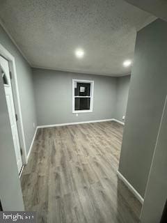 217 S 4th St, Vineland, NJ 08360 - finished below grade area with wood finished floors, baseboards, a textured ceiling, and recessed lighting