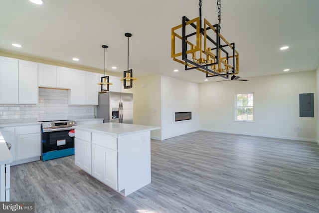 kitchen with electric panel, white cabinets, light wood-type flooring, and appliances with stainless steel finishes