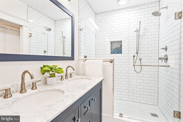 bathroom featuring walk in shower and vanity