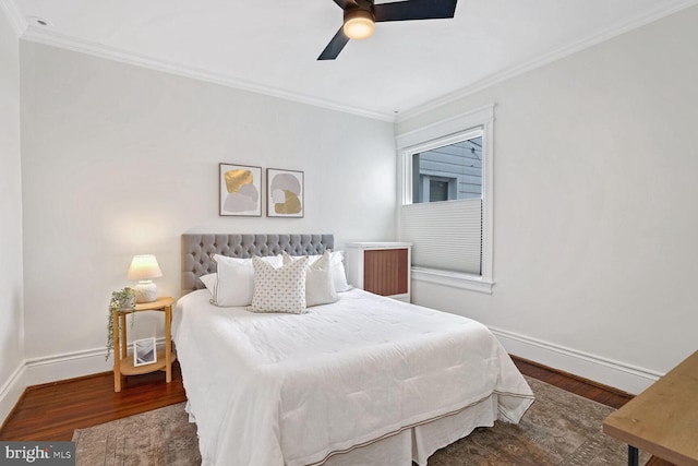 bedroom with crown molding, dark hardwood / wood-style floors, and ceiling fan