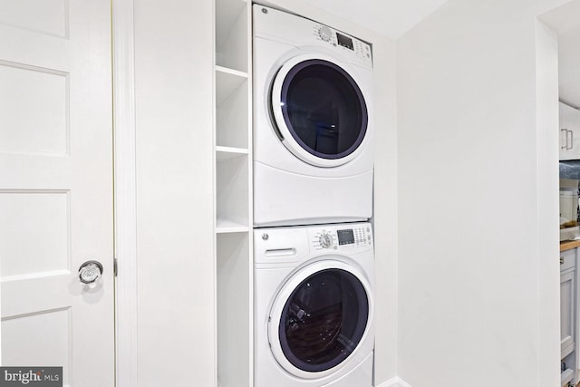 laundry room featuring stacked washer and clothes dryer