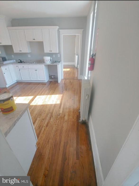 kitchen featuring white cabinets and light wood-type flooring