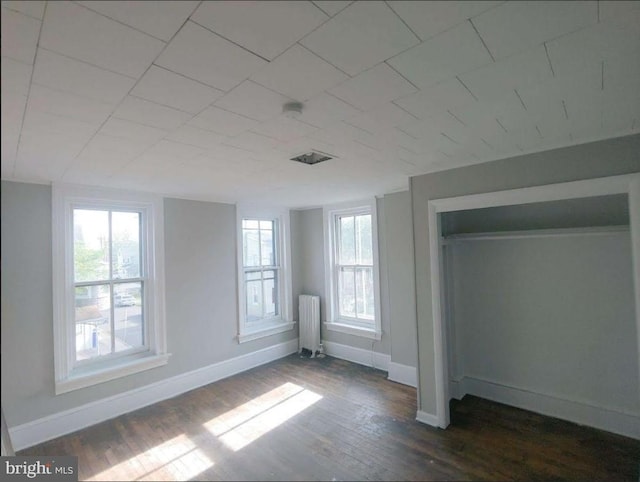 601 King St, Pottstown, PA 19464 - unfurnished bedroom featuring radiator heating unit, baseboards, and dark wood-style floors