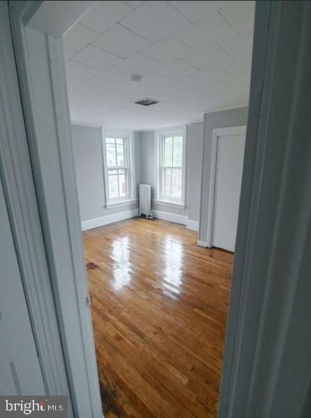 601 King St, Pottstown, PA 19464 - spare room featuring radiator, baseboards, and wood finished floors