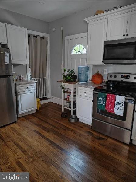 601 King St, Pottstown, PA 19464 - kitchen with appliances with stainless steel finishes, white cabinetry, dark wood-style floors, and light countertops
