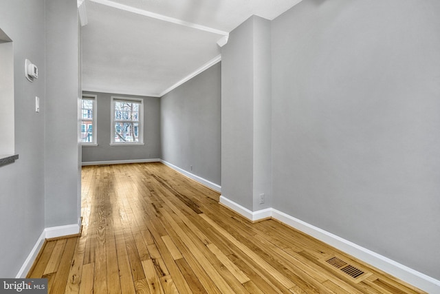 interior space featuring wood-type flooring and ornamental molding