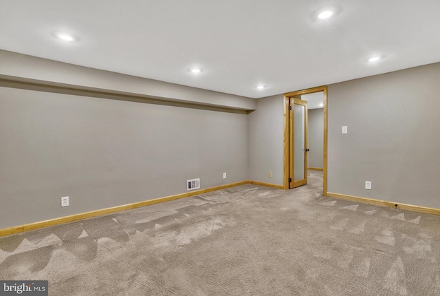 basement featuring light colored carpet