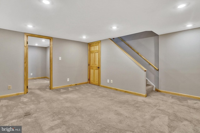 basement featuring light colored carpet