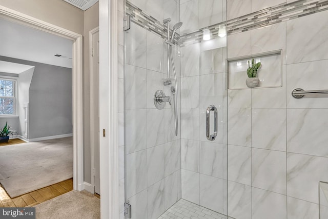 bathroom featuring wood-type flooring and walk in shower