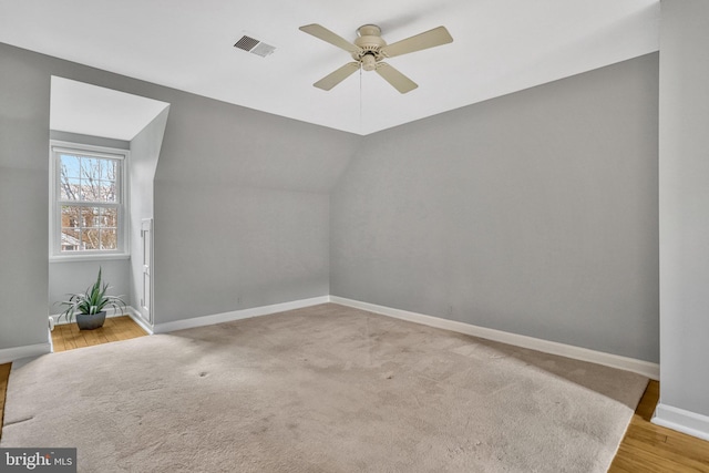 bonus room featuring lofted ceiling, light carpet, and ceiling fan