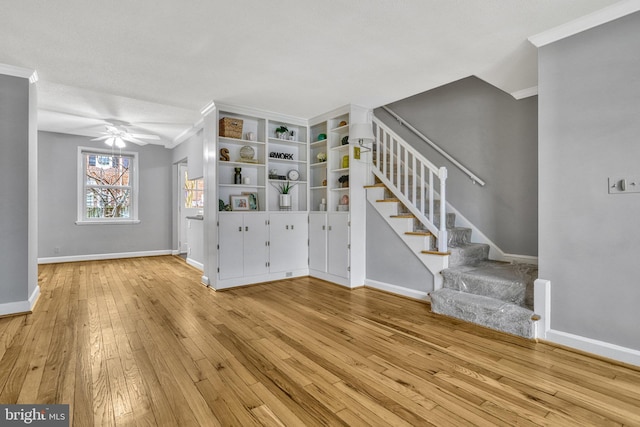 unfurnished living room with crown molding, ceiling fan, and light hardwood / wood-style floors