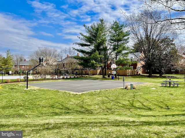 view of sport court featuring a yard