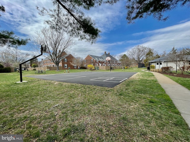 view of basketball court with a yard