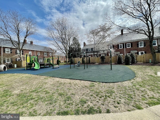 view of property's community featuring a playground and a yard