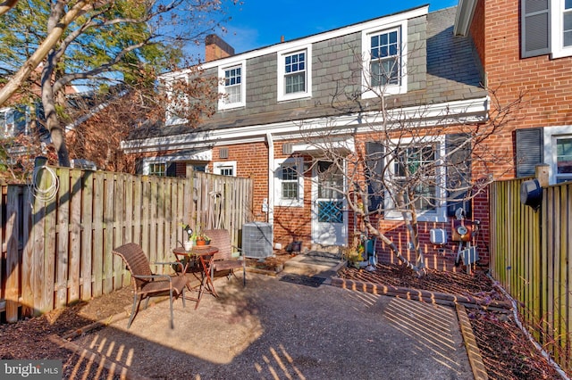 back of house with central AC unit and a patio area