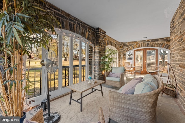 sitting room with a wealth of natural light and brick wall