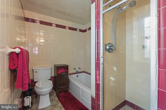 bathroom with tile patterned flooring, plus walk in shower, tile walls, and toilet