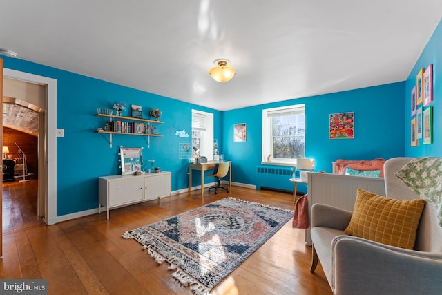 interior space with hardwood / wood-style flooring and radiator heating unit