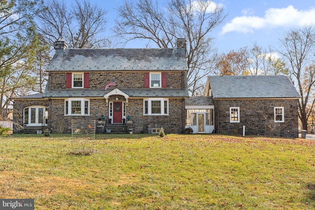 view of front of house with a front yard and french doors