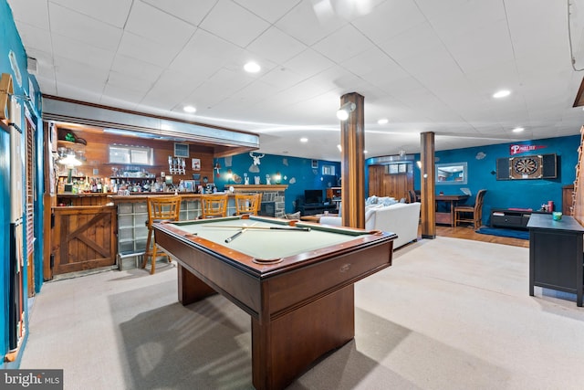 playroom featuring light carpet, pool table, and bar area