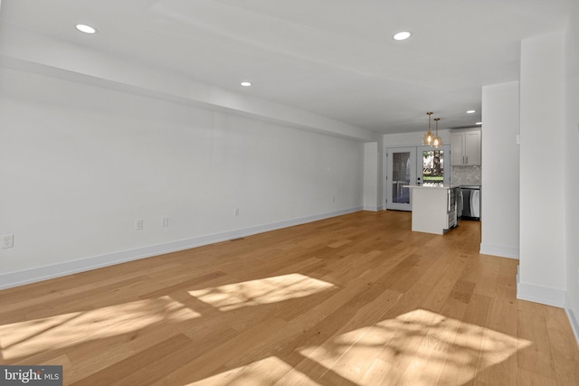 unfurnished living room with light hardwood / wood-style flooring