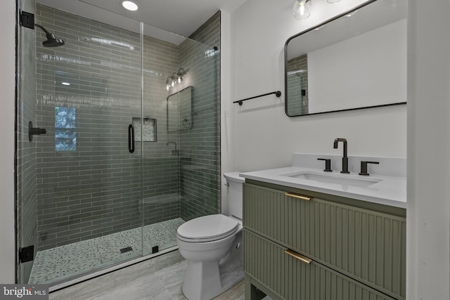 bathroom featuring vanity, toilet, and walk in shower