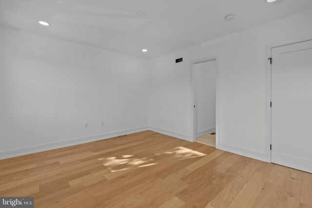 spare room with light hardwood / wood-style flooring