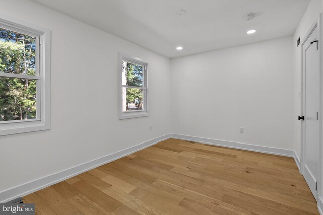 spare room with light hardwood / wood-style floors