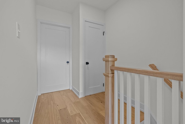 corridor with light hardwood / wood-style flooring