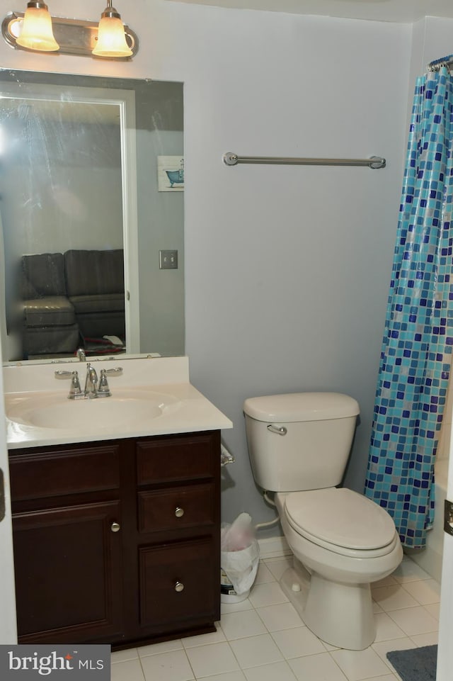 bathroom featuring toilet, vanity, and tile patterned floors