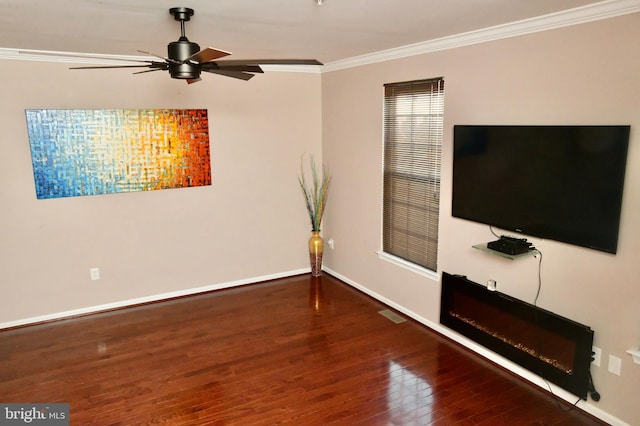 unfurnished living room featuring wood-type flooring, ceiling fan, and crown molding