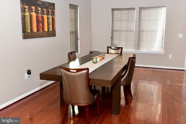 dining area with dark hardwood / wood-style flooring