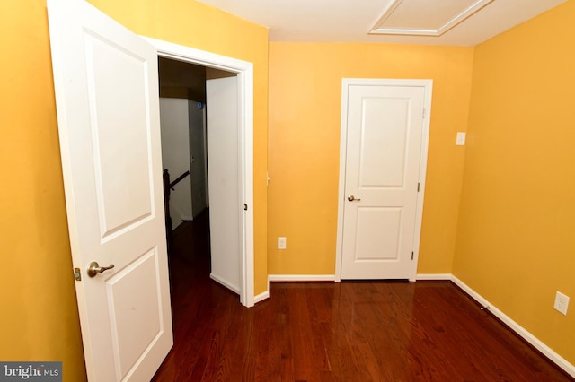 corridor with dark hardwood / wood-style floors