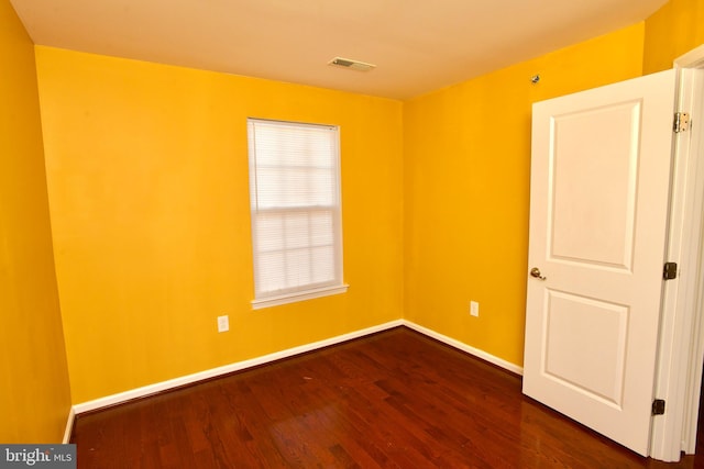 unfurnished room with dark hardwood / wood-style floors