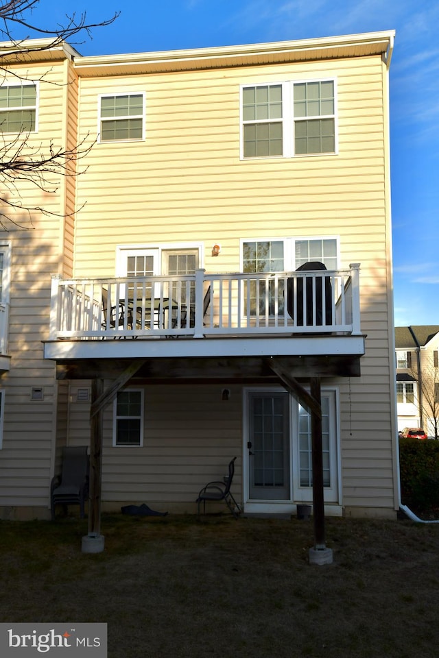 rear view of house featuring a deck