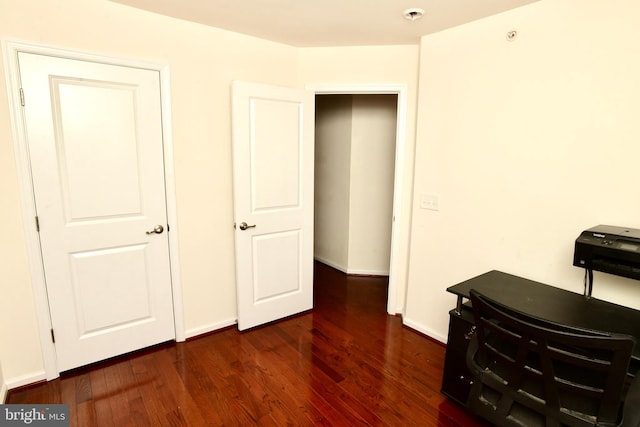 bedroom with dark hardwood / wood-style floors