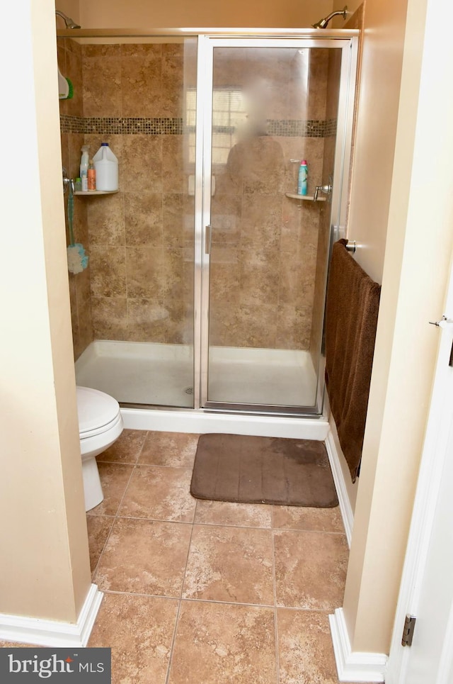 bathroom featuring toilet and walk in shower