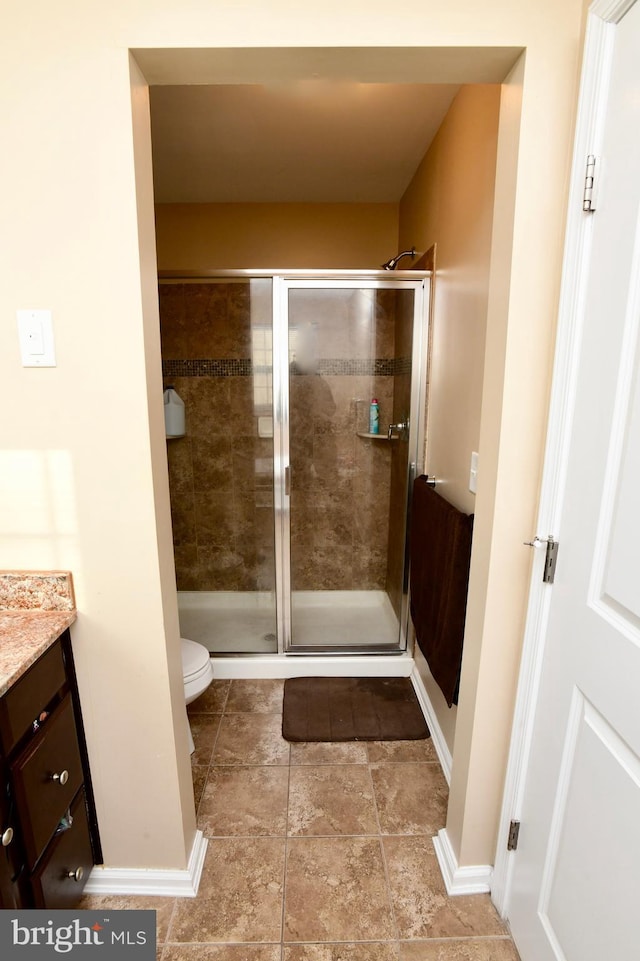 bathroom with vanity, toilet, and walk in shower