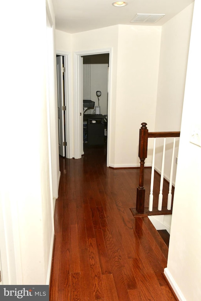 hallway featuring dark hardwood / wood-style flooring