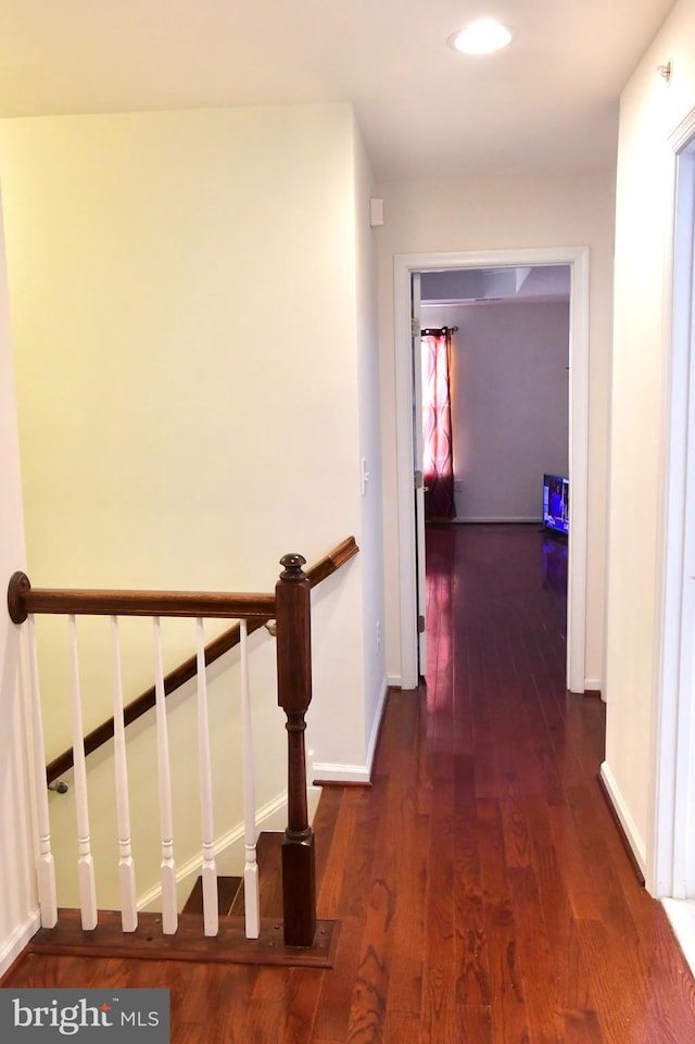 hall with dark hardwood / wood-style flooring