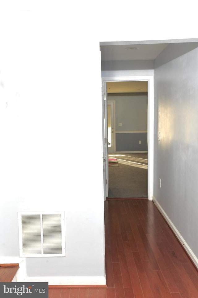 hall with dark wood-type flooring