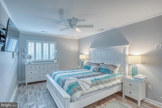 bedroom featuring ceiling fan, light hardwood / wood-style flooring, and ornamental molding