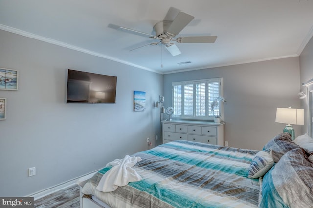 bedroom with ceiling fan, crown molding, and light wood-type flooring