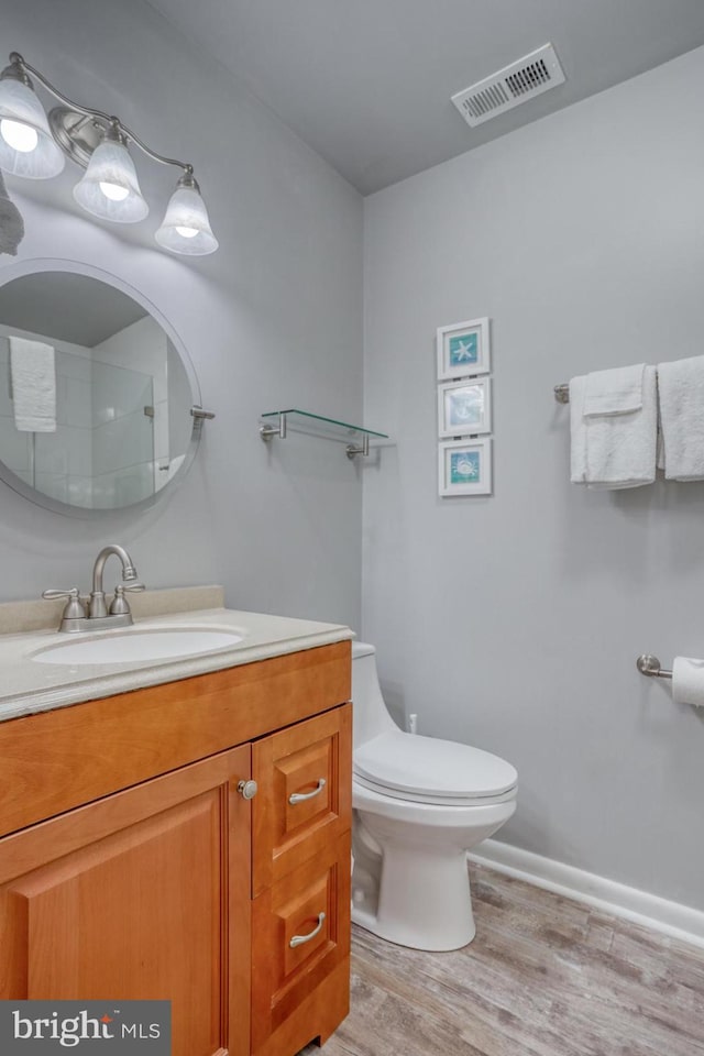 bathroom featuring hardwood / wood-style floors, vanity, and toilet