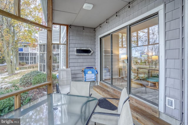 sunroom / solarium featuring a healthy amount of sunlight