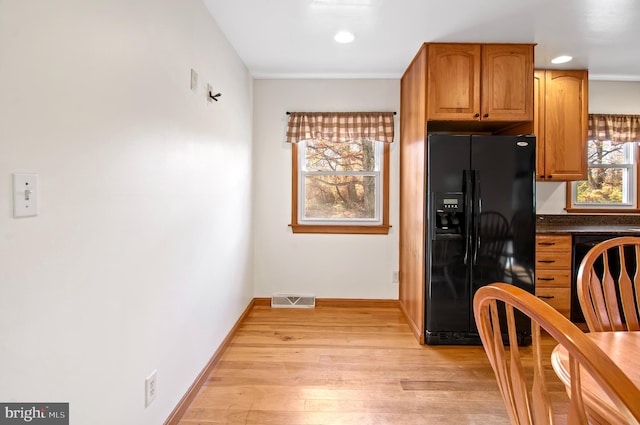 kitchen with black appliances and light wood-type flooring